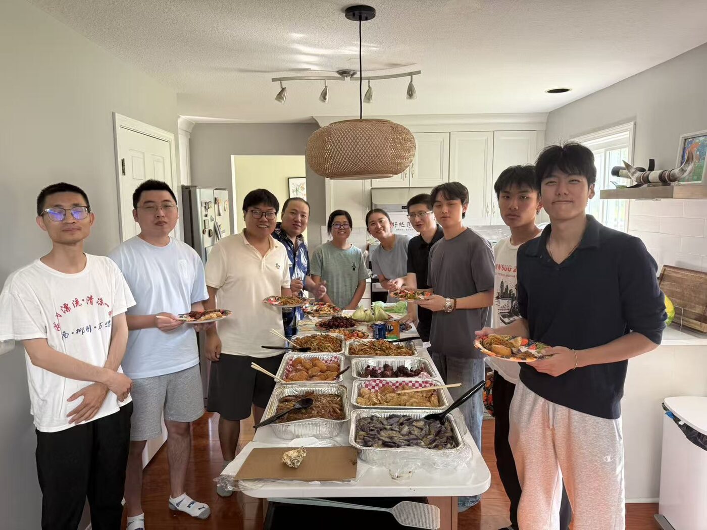 Members of the research group gathered around a shared meal at a group get-together.